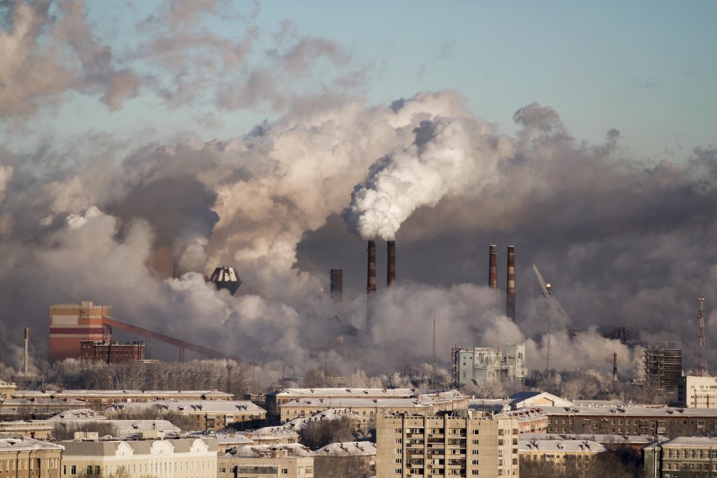 What are some predicted environmental damages if carbon dioxide emissions are not reduced?